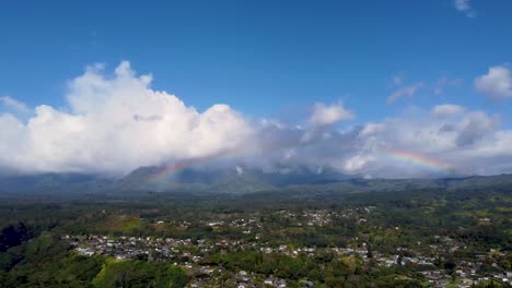 Panning-A-Rainbow-Along-Lush-green-jungle-forest-and-mountains-of-Tropical-Kauai,-Hawaii