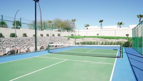 Dolly-revealing-shot-of-the-newly-built-outdoor-tennis-courts-during-summer