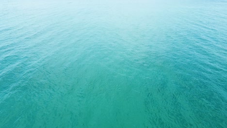 Aerial-top-down-view-of-the-sea-surface-with-deep-blue-water,-moving-forward
