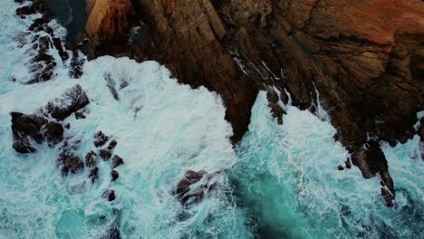 Drone-of-Light-Blue-Waves-Crash-at-Bermagui-Blue-Pool-Rocks,-Australia