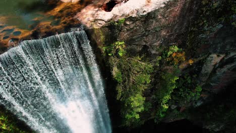 Belmore-Falls,-Australia,-Drone-Pans-Down-Waterfall,-Revealing-Couple-Atop