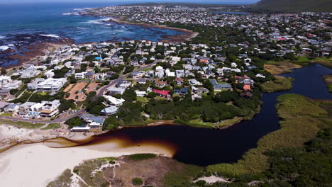 High-angle-view-over-coastal-town-Onrus-and-tannin-rich-lagoon,-Cape-Whale-Coast