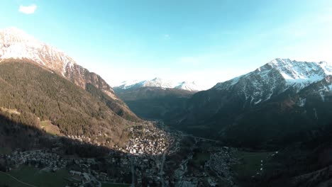 FPV-drone-aerial-over-alpine-mountain-resort-Courmayeur,-Aosta-Valley,-Italy,-Mont-Blanc-Monte-Bianco,-flying-over-sunny-alps-valley