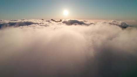 Aerial-ascent-of-clouds-and-sun,-Madeira,-Portugal