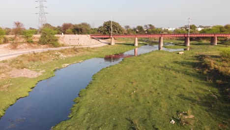 Railway-track-bridge-crossing-over-the-factory's-waste-water-canal