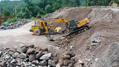 Excavator-and-loader-by-heap-of-sand-in-processing-site-of-Merapi-Mine-Indonesia