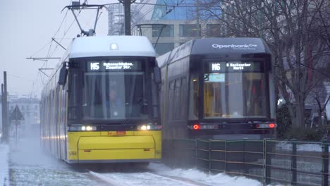 Yellow-Tram-Driving-on-Snowy-Rails-on-Cold-Winter-Day-in-Berlin