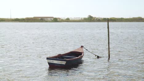4K-Old-wooden-fishing-boat-moored-in-the-middle-of-Ria-de-Aveiro