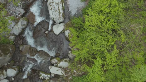Drone-view-flying-down-beautiful-mountain-stream-in-Tottori-Japan