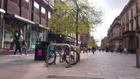 People-walking-past-a-bike-stand-in-a-quiet-city-centre