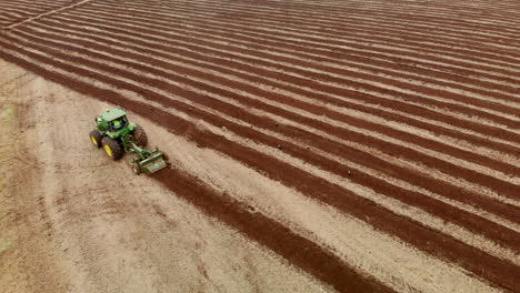 Tractor-plowing-the-land,-preparing-the-soil-for-planting