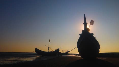 Traditional-Caribbean-fishing-trawlers-on-beach-at-sunset,-Saint-Martin-island