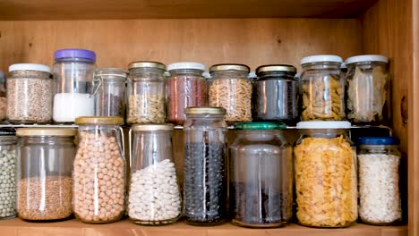 Sliding-reveal-of-wooden-cupboard-of-spice-jars