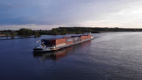 Inland-Freight-Ship-Carrying-Heap-Of-Intermodal-Containers-On-Oude-Maas-River-Near-Barendrecht,-Netherlands