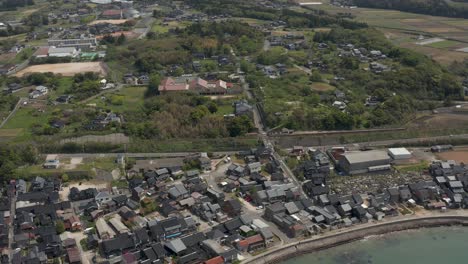 Aerial-flying-over-Rural-Japanese-Town-on-Sea-of-Japan,-Mikuriya,-Tottori