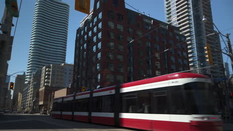 Wide-shot-of-a-TTC-streetcar-travelling-through-the-busy-intersection-at-Carlton-and-Jarvis-Streets