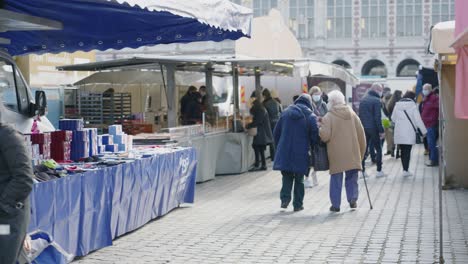 Friday-market-at-Ladeuze-square-in-Leuven-during-Belgian-coronavirus-pandemic---close-slow-motion-shot