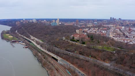 Aerial-panoramic-view-over-Hudson-River-Greenway-and-Cloisters-at-Fort-Tryon-Park,-New-York