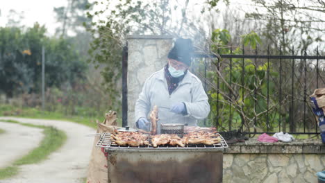 Female-Villager-Wearing-Face-Mask-Selling-Grilled-Chicken-On-Sidestreet-In-Leiria,-Portugal