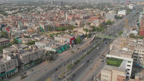 Aerial-View-Of-Highway-With-Traffic-Passing-In-Lahore-City-And-Birds-Flying-Past