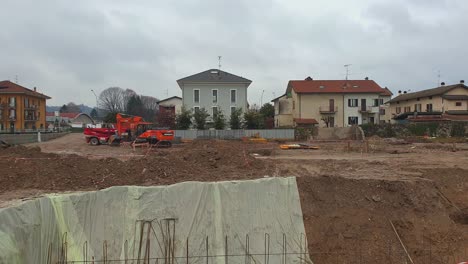 Red-machinery-for-foundations-excavation-works-on-construction-residential-urban-area-of-Arona