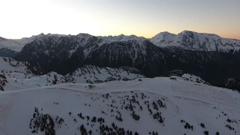 Chamrousse-French-alps-during-sunrise-above-the-main-ski-tracks,-Aerial-flyover-shot