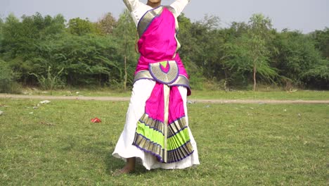A-bharatnatyam-dancer-displaying-a-classical-bharatnatyam-pose-in-the-nature-of-Vadatalav-lake,-Pavagadh