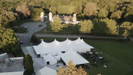 Luxury-celebration-tent-while-party-is-going-on-in-aerial-drone-view