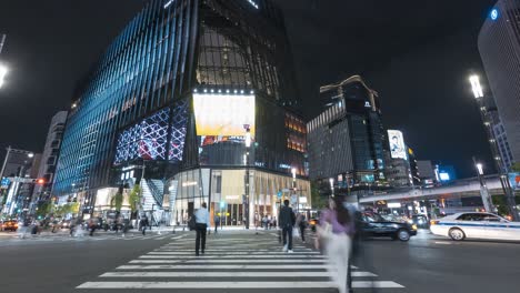Tokyu-Plaza-Shopping-Mall-At-Ginza-With-Traffic-In-Foreground-At-Night-In-Tokyo,-Japan