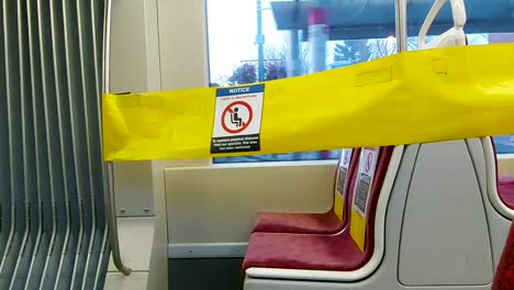 Seats-blocked-off-with-yellow-tape-and-notice-signs-on-streetcars-in-Toronto-during-COVID-19-pandemic