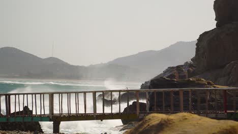 Viewing-platform-by-sea-waves-hit-rocky-shore,-Hang-Rai-coast,-Vietnam