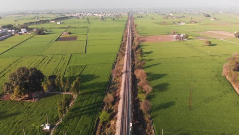 Eine-Lange,-Gerade-Eisenbahnstrecke-überquerte-Die-Grünen-Landwirtschaftlichen-Felder