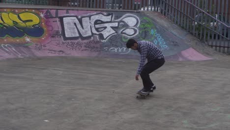 Slow-mo-of-skate-boarder-jumping-at-a-skate-park-in-Sheffield,-England