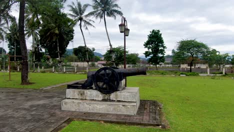Cannon-in-Park-of-Kedu-Residency-Dutch-colonial-building,-Magelang,-Indonesia