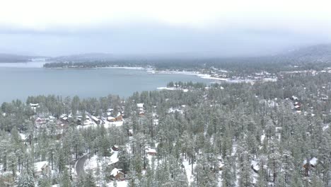 Aerial-view-panning-over-Big-Bear-Lake-during-a-spring-snow-storm-in-the-Southern-California-Mountains