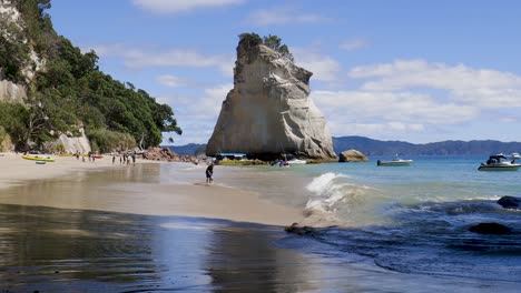 Wide-slow-panning-shot-of-waves-at-Te-Hoho-rock-and-Cathedral-cove-beach