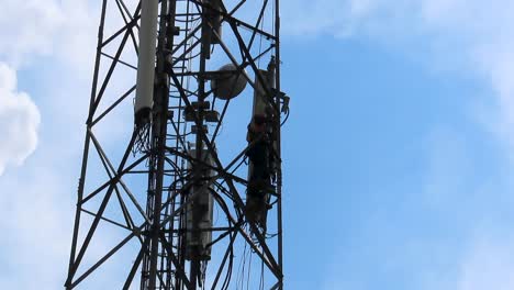 Man-pushing--cell-tower-antenna-after-loosening-it