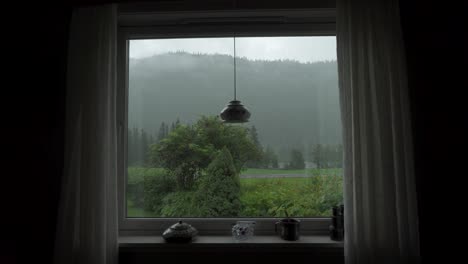 Window-view:-hill-side-nature-with-passing-car-at-the-road,-static-shot