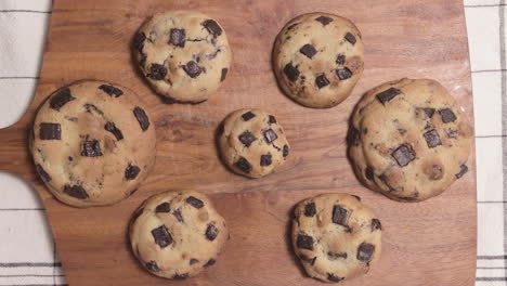 Dough-With-Roling-Pin-Turned-Into-Round-Cookie-Chips-On-Wooden-Board
