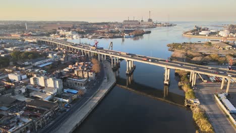 Aerial-of-highway-traffic-and-industrial-area-by-water-in-Buenos-Aires