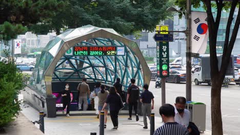 Gangnam-Subway-Station-Exit-One---Korean-People-In-Protective-Face-Masks-Enter-and-Exit-Subway-During-Covid-19-Corona-Virus-Pandemic---28-July-2021