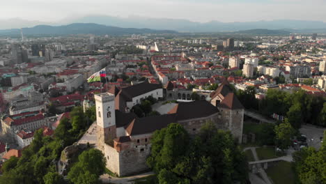 Flying-over-Ljubljana-castle-with-drone-in-overseeing-the-city-buildings