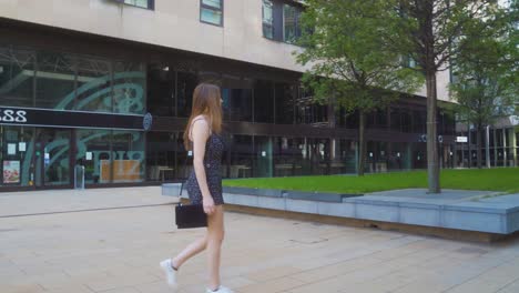 Walking-gimble-shot-of-young-blonde-woman-walking-through-Sheffield-city-centre-in-summer