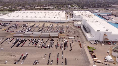 Delivery-Trucks-And-Cars-Parked-At-The-Parking-Area-Of-FCA-Stellantis-Assembly-Plant-In-Sterling-Heights,-Michigan