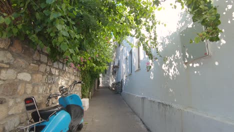 Vespa-scooters-parked-along-narrow-lovely-alley-of-Bodrum,-Turkey