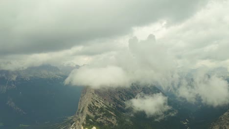 Fly-towards-clouds-rocky-mountain-range,-dolomites-south-tyrol-italy