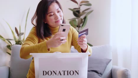 Woman-reserving-delivery-to-forward-box-with-clothing-donations