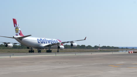 Edelweiss-Airbus-On-The-Taxiway-Of-Ibiza-Airport-In-Spain-At-Daytime