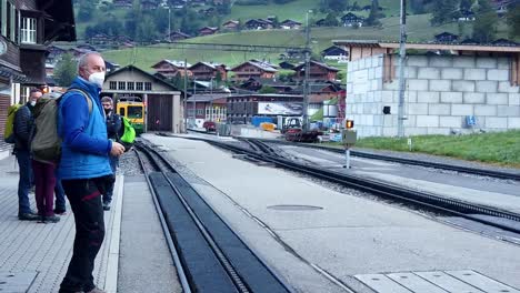 European-man-with-backpack-walking-by-the-side-of-the-train-railway-station