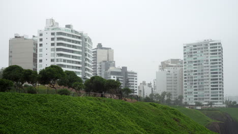 Apartment-building-residences-on-clifftop-on-a-windy-day-at-Malecon-de-Miraflores,-Lima,-Peru